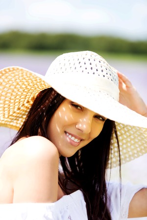 Happy woman in summer field. Young girl relax outdoors. Freedom concept.の写真素材