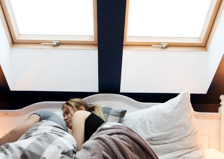 Loving family sleeping in bedの写真素材