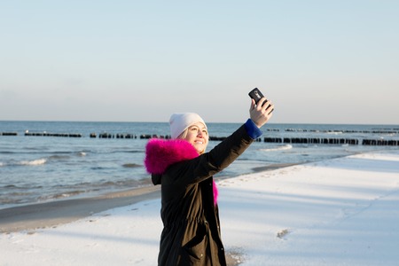 Beautiful young teen girl having fun and making selfie.の写真素材