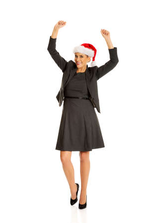 Happy businesswoman wearing christmas hatの写真素材