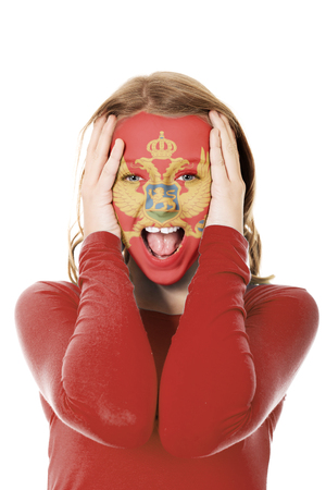 Woman face painted with flag of Montenegro.の写真素材