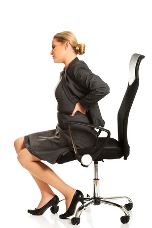 Businesswoman having back painの写真素材