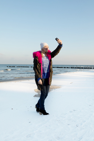 Beautiful young teen girl having fun and making selfie.の写真素材