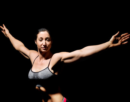 Muscular bodybuilder woman showing her muscles.