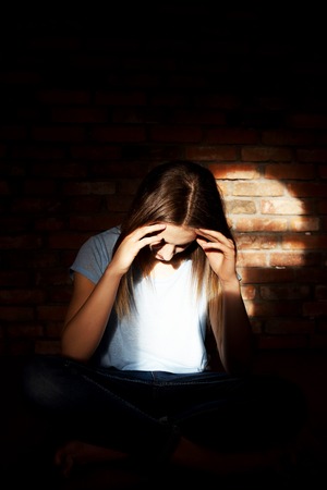 Sad woman in the roomの写真素材