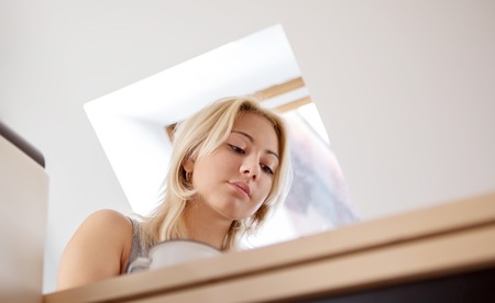 Teen girl using cell phone at homeの写真素材
