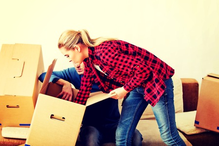 Young couple with boxes - packing or unpackingの写真素材