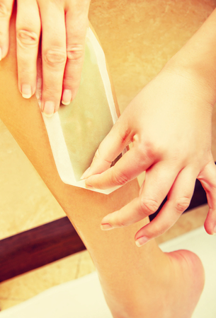 Woman shaving her leg waxの写真素材