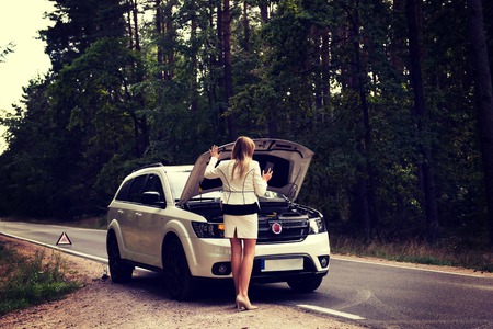 Woman opened the hood broken carの写真素材