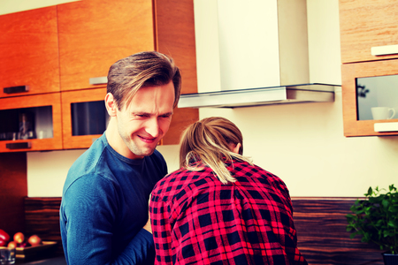 Young couple dancing and having fun in the kitchenの写真素材