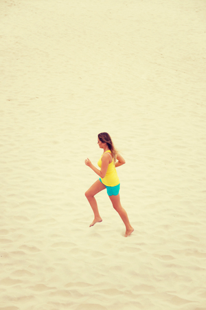 Young woman running on the beachの写真素材