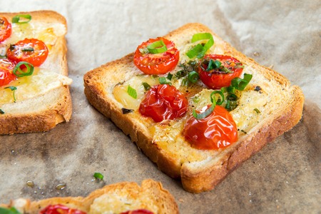 Grilled toast with camembert and cherry tomatoes.の写真素材