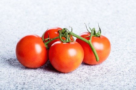 Four red fresh juicy tomatoes.の写真素材