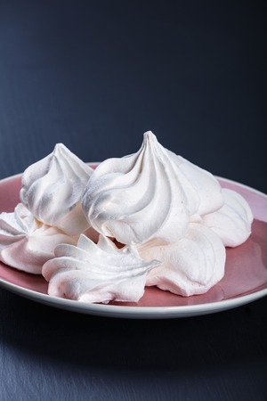 Heap of fluffy meringue on the plate.の写真素材