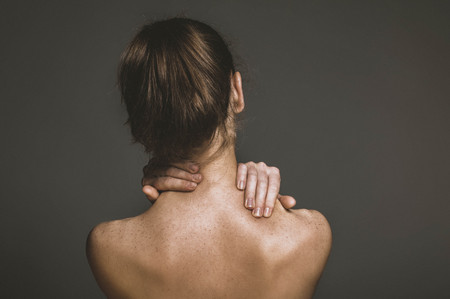 Woman suffering for chronic neck painの写真素材