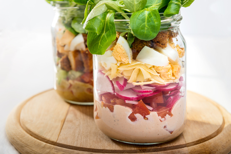 Two glass jars with fresh salad.の写真素材