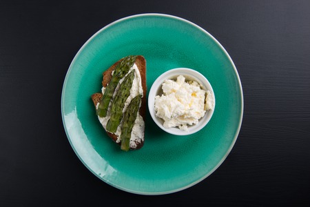 Single sandwich with cream cheese and asparagus and cream cheese in bowlの写真素材