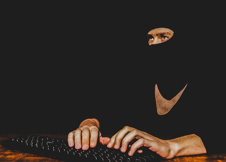Hacker typing on keyboardの写真素材