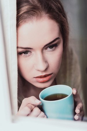 Serene woman with cupの写真素材