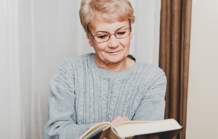 Elderly woman reading bookの写真素材