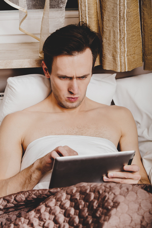 Reading morning news on tabletの写真素材