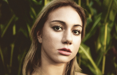 Blond woman in tropical forestの写真素材