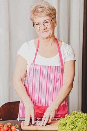 Mature woman preparing mealの写真素材