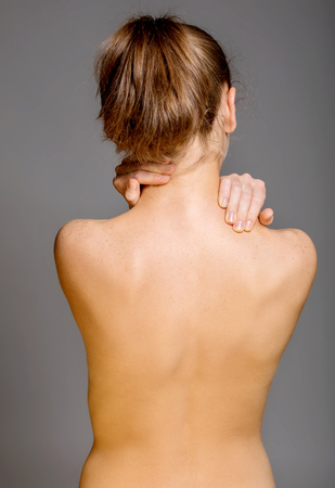 Nude womans back on greyの写真素材