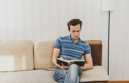 Man reading book in homeの写真素材