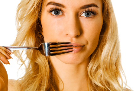 Woman with fork on lipsの写真素材