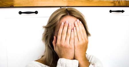 Depressed woman with covered faceの写真素材