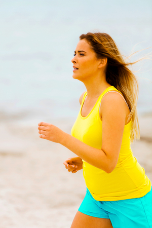 Woman jogger on beachの写真素材