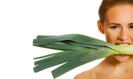 Woman with leek in mouthの写真素材