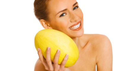 Woman with melon on whiteの写真素材
