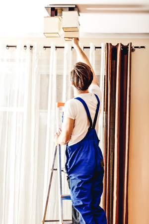 Handyman changing the bulbの写真素材