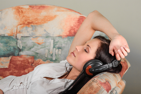 Lying woman with headphonesの写真素材