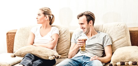 Man with beer on sofaの写真素材