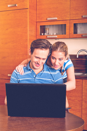 Smiling couple with laptopの写真素材