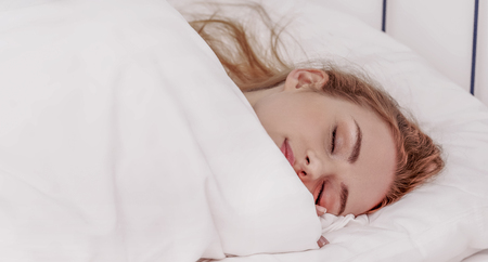 Woman sleeping in bedの写真素材