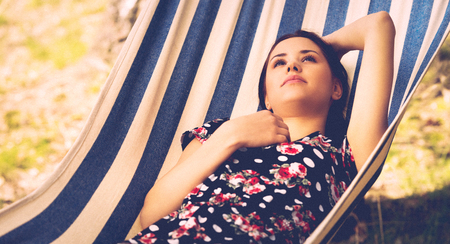 Woman relaxing in the hammockの写真素材