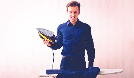 Man is ironing clothesの写真素材