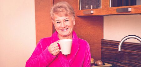 Senior woman with cup of coffeeの写真素材