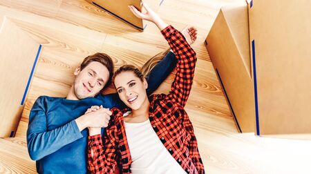Smiling couple lying on floorの写真素材