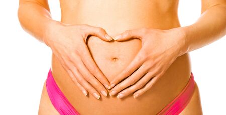 Heart shape on pregnant bellyの写真素材