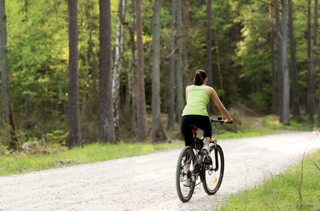 Woman riding bike outsideの写真素材