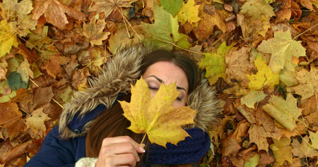 Young woman in autumn park with leafs