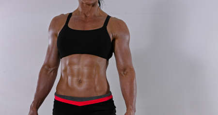 Muscular abdomen of fitness woman. Bodybuilding concept.の写真素材