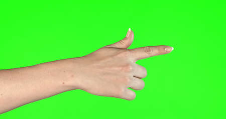 Female hand gestures on green screen: pointing or pressing.の写真素材