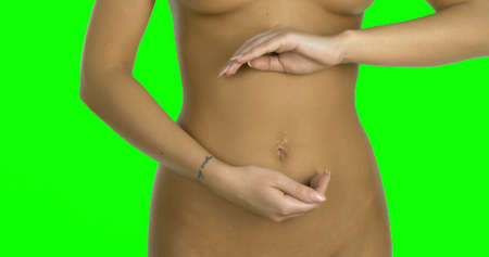 Woman belly close up. Touching with handsの写真素材