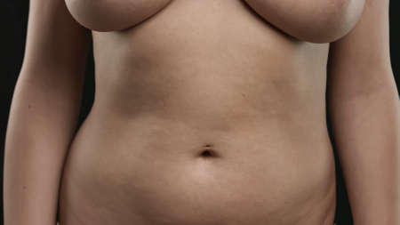 Woman touching her belly.の写真素材